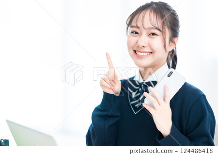 Smiling high school girl pointing at something 124486418