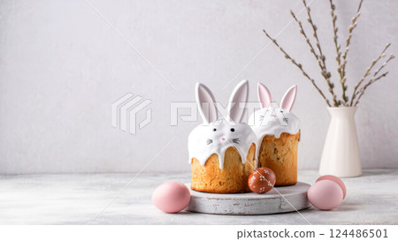 Easter cakes with bunny ears and painted eggs on a light background with space for text. Happy Easter concept. 124486501