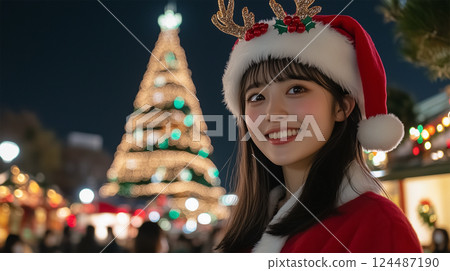 Night illumination and a smiling Japanese woman in a Santa costume Night illumination and a smiling Japanese woman in a Santa costume 124487190