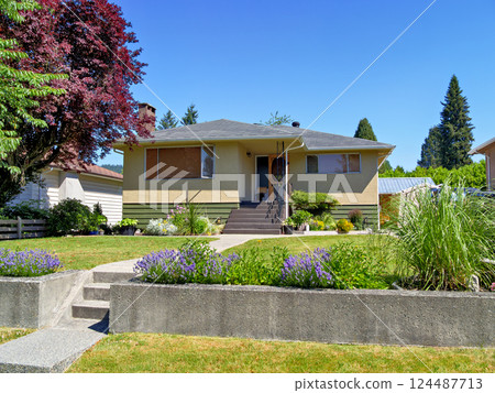 A perfect neighborhood. Neat residential house on the land terrace with flowers 124487713