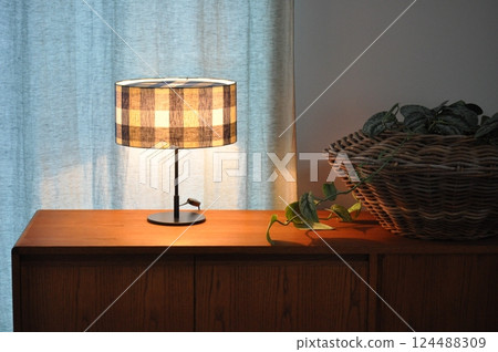 Lamp shade on a sideboard 124488309