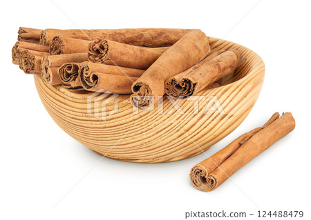 Cinnamon sticks in wooden bowl isolated on white background with full depth of field. 124488479