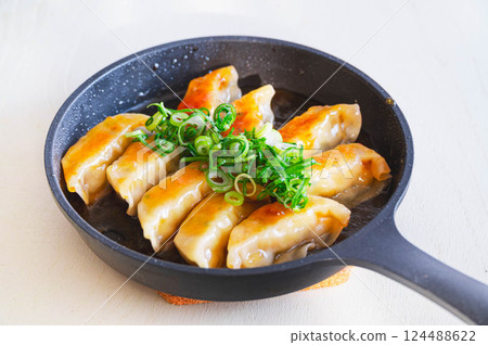 Sweet and sour gyoza dumplings 124488622
