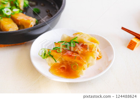Sweet and sour gyoza dumplings 124488624