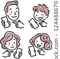 A family of four with smartphones 124488670