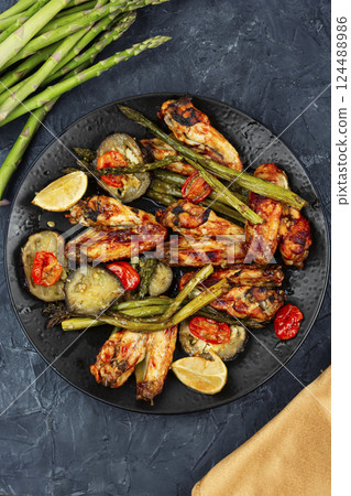 Fried chicken wings with asparagus. Fried chicken wings with asparagus. 124488986
