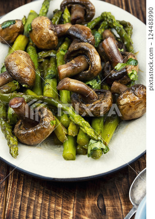 Roasted juicy asparagus with champignons. 124488990