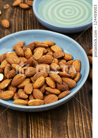Almond oil with almond seeds. Almond oil with almond seeds. 124489003