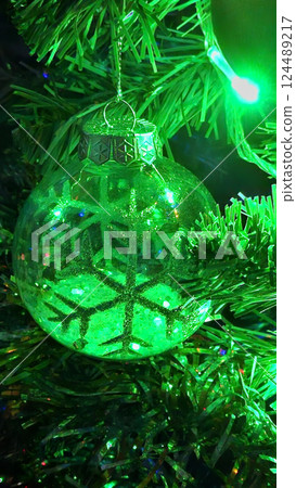 Christmas tree decorated with beautiful transparent ball with abstract snowflake Christmas tree decorated with beautiful transparent ball with abstract snowflake 124489217