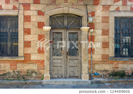 Antique wooden door. Door of old building Antique wooden door. Door of old building 124489608