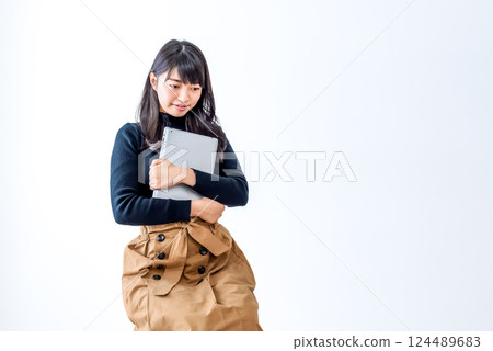 Young woman sitting with a tablet Young woman sitting with a tablet 124489683