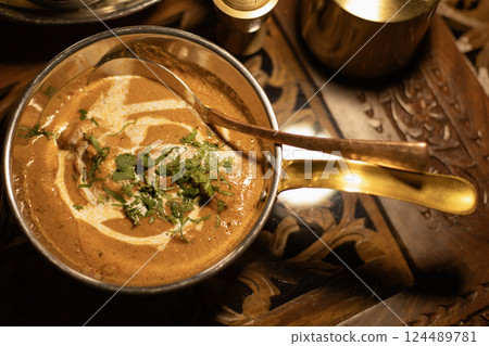 Indian dish, chicken in curry sauce top view Indian dish, chicken in curry sauce top view 124489781