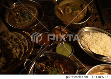 set of Indian cuisine dishes on the table 124489783