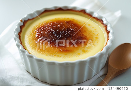A close-up of a baked custard dish, a French custard dessert with a caramelized sugar crust. 124490450