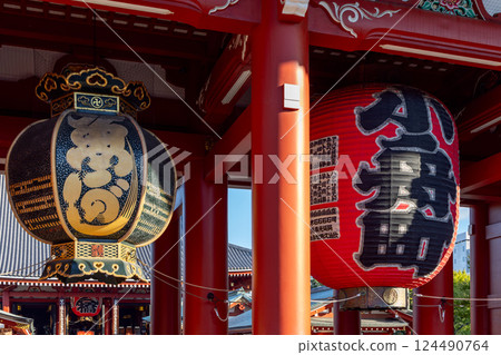 Ornate temple lanterns at Senso-ji Temple, highlighting their gold and red colors Ornate temple lanterns at Senso-ji Temple, highlighting their gold and red colors 124490764