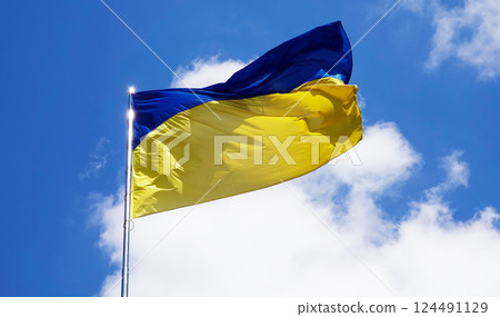 Kyiv, Ukraine, April 27, 2024: the flag of Ukraine on the rod flutters in a strong wind 124491129