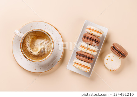 A delightful combination of freshly brewed coffee and delicate macaroons A delightful combination of freshly brewed coffee and delicate macaroons 124491210