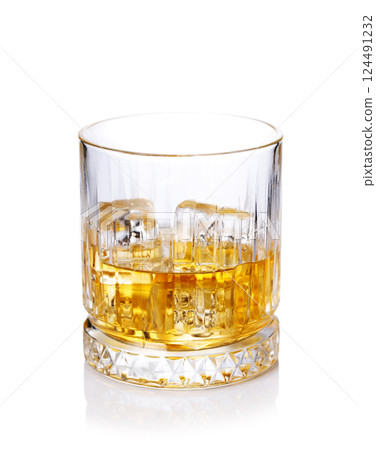 A classic whiskey glass filled with golden amber whiskey 124491232