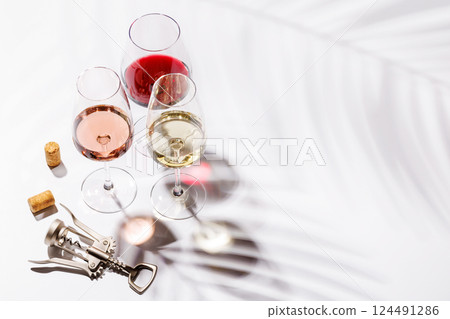 Three wine glasses filled with red, white, and rose wine 124491286