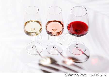 Three wine glasses filled with red, white, and rose wine 124491287