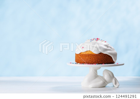 Traditional Easter cake decorated with colorful icing and sprinkles, symbolizing the festive spirit Traditional Easter cake decorated with colorful icing and sprinkles, symbolizing the festive spirit 124491291