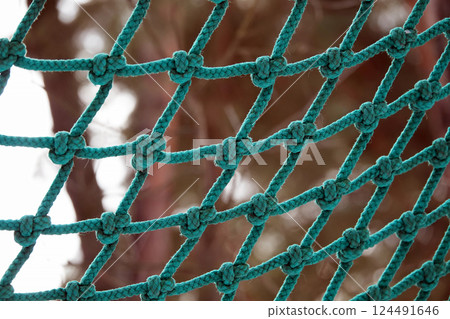Ropes woven into a net for climbing people in the park Ropes woven into a net for climbing people in the park 124491646