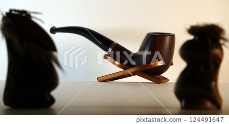 Kiev, Ukraine December 2, 2017: smoking pipe and the gods of smoking Kiev, Ukraine December 2, 2017: smoking pipe and the gods of smoking 124491647