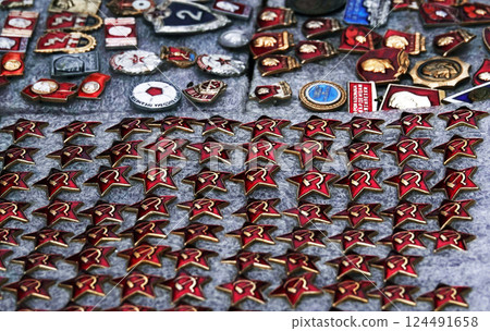 Kiev, Ukraine November 15, 2019: badges of the era of the Soviet Union are sold as a rarity on a city street 124491658