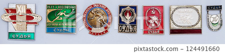 Kiev, Ukraine August 16, 2021: Lapel badges of judges who took part in the Spartakiads of students and schoolchildren in handball of the USSR era 124491660