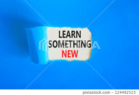 Learn something new symbol. Concept words Learn something new on beautiful white paper. Beautiful blue paper background. Business motivational lifestyle learn something new concept. Copy space. 124492523