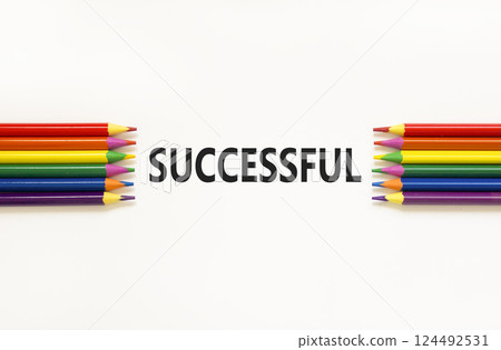 Successful symbol. Concept word Successful on beautiful white paper. Beautiful white paper background. Beautiful colored pencils. Business successful concept. Copy space. 124492531