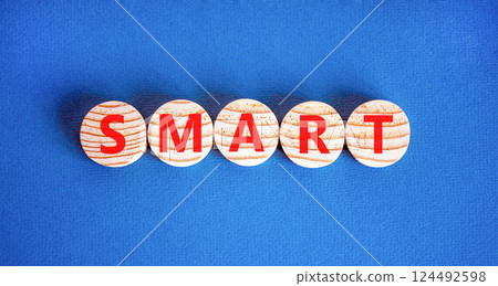 Smart symbol. Concept word Smart on beautiful wooden circles. Beautiful blue table blue background. Business lifestyle smart concept. Copy space. 124492598