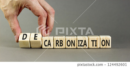 Decarbonization or carbonization symbol. Concept words Decarbonization or Carbonization on wooden blocks. Beautiful grey background. Business decarbonization or carbonization concept. Copy space. 124492601