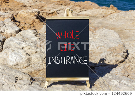 Whole life insurance symbol. Concept words Whole life insurance on beautiful black yellow blackboard. Beautiful stone and blue sea sky background. Business whole life insurance concept. Copy space. 124492609