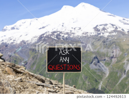 Ask any questions symbol. Concept words Ask any questions on beautiful black yellow blackboard. Beautiful mountain Elbrus background. Business ask any questions concept. Copy space. 124492613