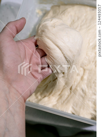 Hands Kneading Fresh Bread Dough 124493057