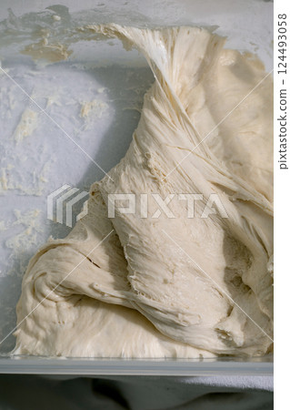 Creamy Dough Folds in Making Process Creamy Dough Folds in Making Process 124493058