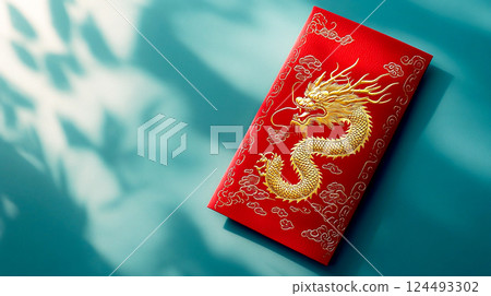 Red envelope with gold engraved dragon in Chinese style on blue background top view. Traditional gift for lunar New Year in China. Symbol of wealth. This is AI-generated item 124493302