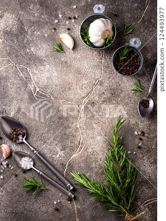 Rosemary, garlic, salt and pepper. 124493977