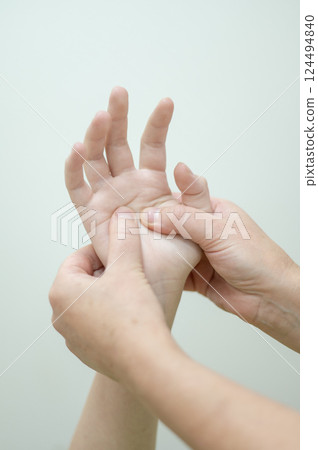Close-up of female hands during massage. Vertical photo.  124494840