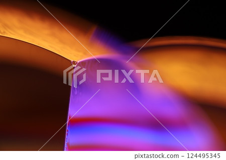 Orange and purple liquid texture in macro, bright fluid, bubbles in macro, dark background, copy space, perfect water edges Orange and purple liquid texture in macro, bright fluid, bubbles in macro, dark background, copy space, perfect water edges 124495345