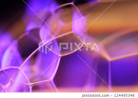 Orange and purple liquid texture in macro, bright fluid, bubbles in macro, dark background, copy space, perfect water edges 124495346