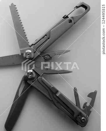 Fully Opened Blades Of Folded Steel Multi Tool with Pliers and Screwdrivers on White Surface Black and White Image Fully Opened Blades Of Folded Steel Multi Tool with Pliers and Screwdrivers on White Surface Black and White Image 124495815