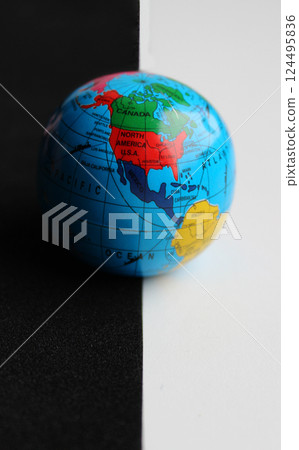 North America Continent on Small Earth Model Over Straight Border of Black and White Backdrops 124495836