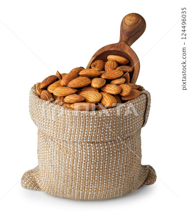 Almond nuts in sack and wooden spoon inserted on top isolated on white background Almond nuts in sack and wooden spoon inserted on top isolated on white background 124496035