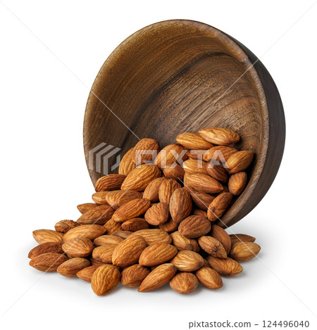 Raw almonds spilling from wooden bowl isolated on white background 124496040
