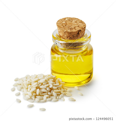 sesame oil in glass bottle and heap seeds isolated on white background. Healthy eating concept 124496051