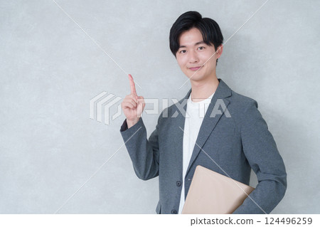 Pointing businessman in office casual wear Pointing businessman in office casual wear 124496259