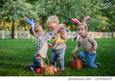 Children Playing and Sharing Easter Eggs During Outdoor Hunt Children Playing and Sharing Easter Eggs During Outdoor Hunt 124496347