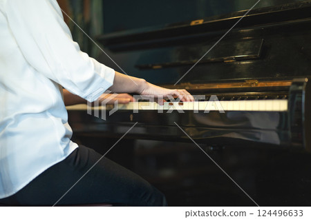 A woman's hand playing the piano 124496633